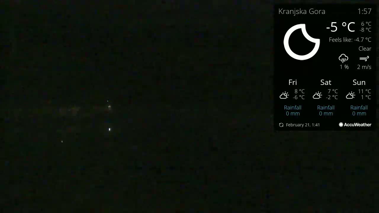 A nighttime outdoor scene shows a clear sky with a few distant lights visible in the dark.