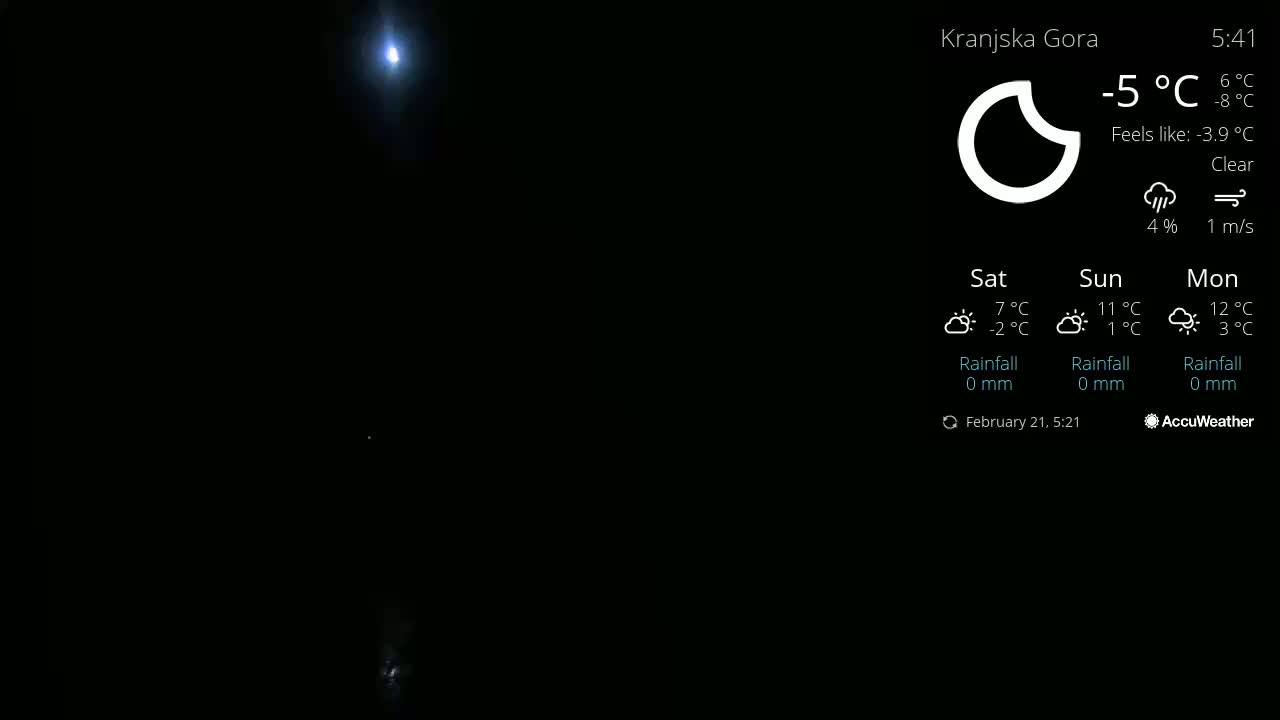 A bright moon shines in a clear night sky.