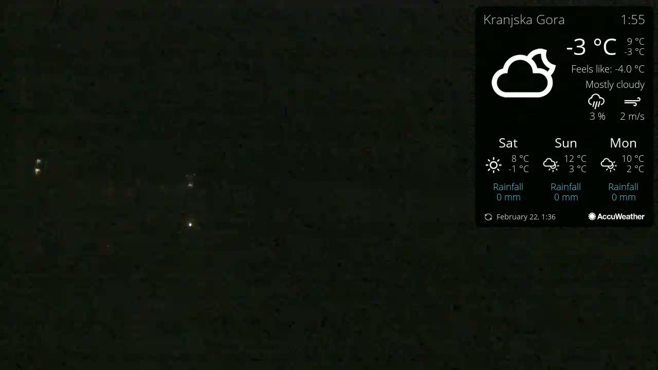 A mostly cloudy night sky with a few distant lights visible under a -3°C temperature.