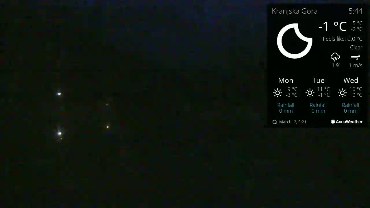 Under a clear night sky, several distant lights are visible.