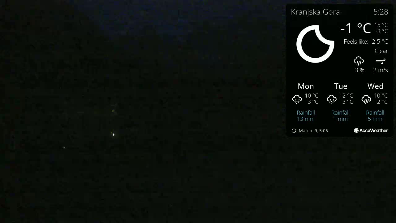 A dark, nighttime outdoor scene shows a few distant lights under a clear sky with a temperature of -1°C.