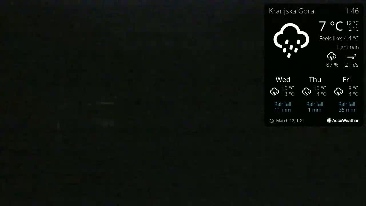 A dark, mostly black image shows a weather forecast for light rain with a temperature of 7°C.