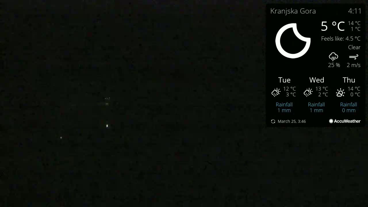 A nighttime outdoor scene showing a clear sky with a few distant lights visible, and the temperature is 5°C.