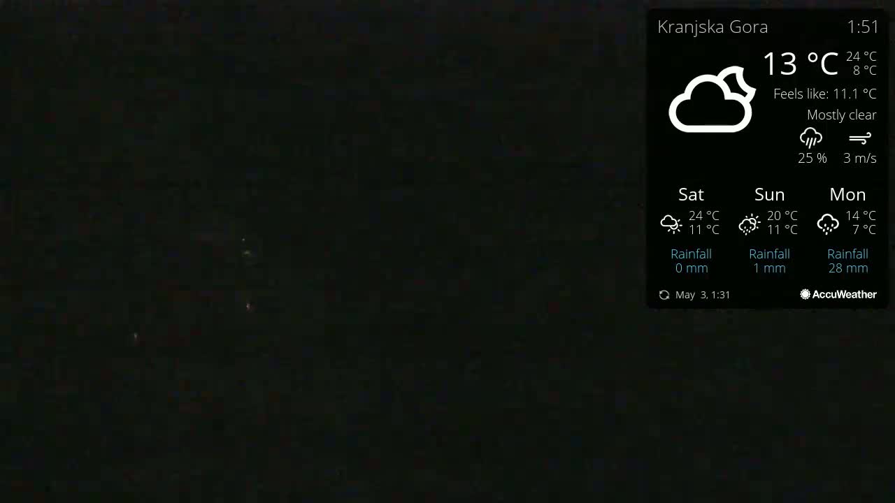 A mostly clear night sky is shown, with a few faint lights visible in the distance.