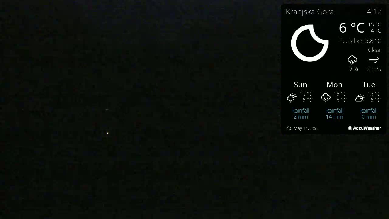 A nighttime outdoor scene shows a clear sky with a few faint lights visible in the distance.