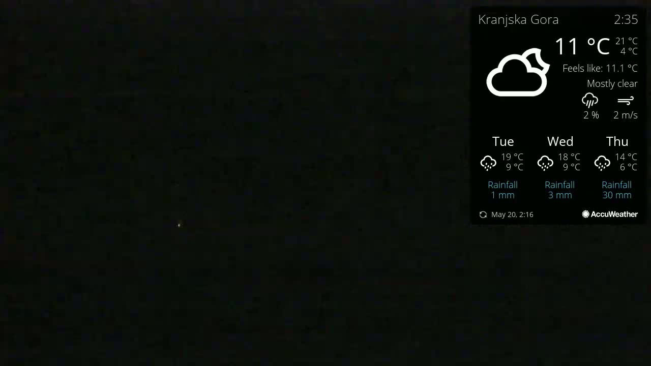 A mostly clear night sky is visible, with a faint light source in the distance.