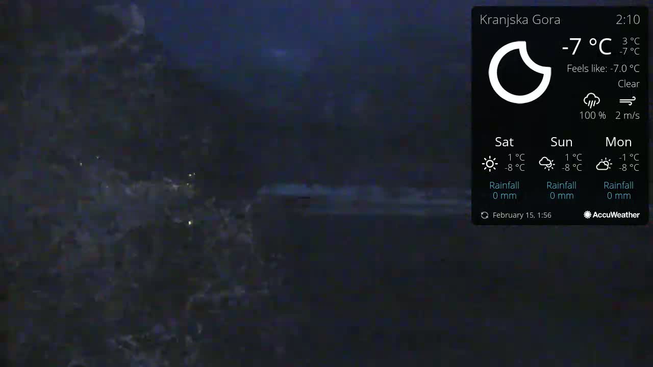 A dark, nighttime scene of what appears to be a body of water with small waves under a clear sky, the temperature is -7°C.