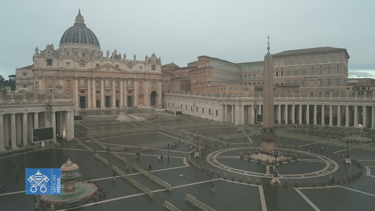 St. Peter's Basilica and Square in Vatican City on a cloudy, wet day, with sparsely populated grounds and temporary barriers in place.