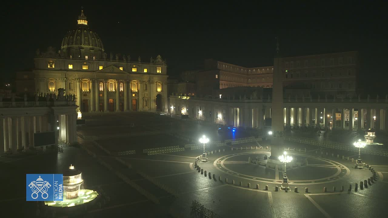 St. Peter's Basilica and St. Peter's Square are illuminated at night, with a fountain at the center of the square.