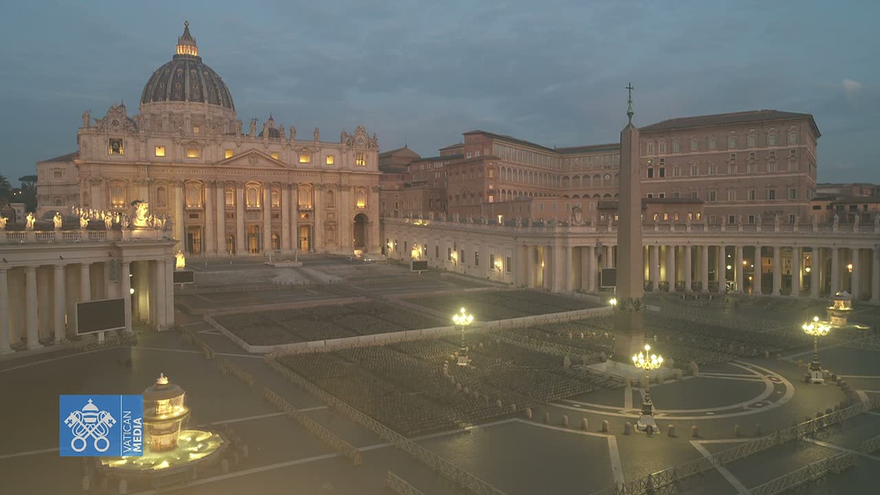 St. Peter's Basilica and Square at dusk, with many empty chairs set up in the square.