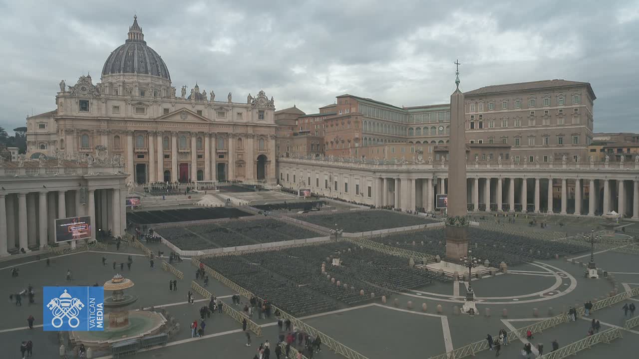 St. Peter's Basilica and St. Peter's Square in Vatican City are shown on an overcast day, with many empty chairs set up in the square.