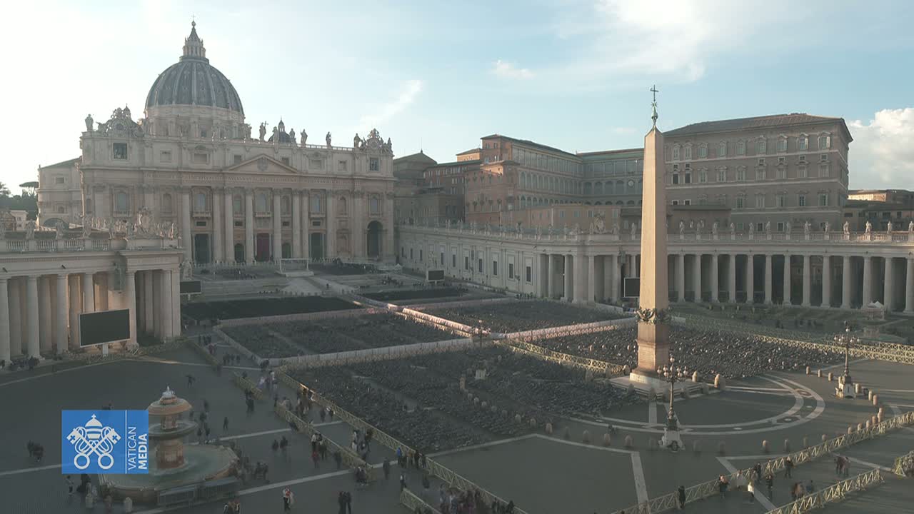 A large, mostly empty plaza in front of St. Peter's Basilica on a bright, sunny day.