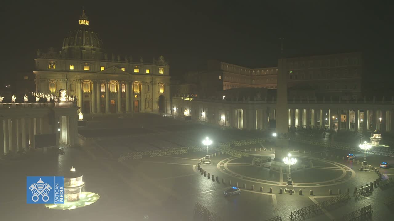 St. Peter's Basilica and St. Peter's Square at night, under a dark sky.