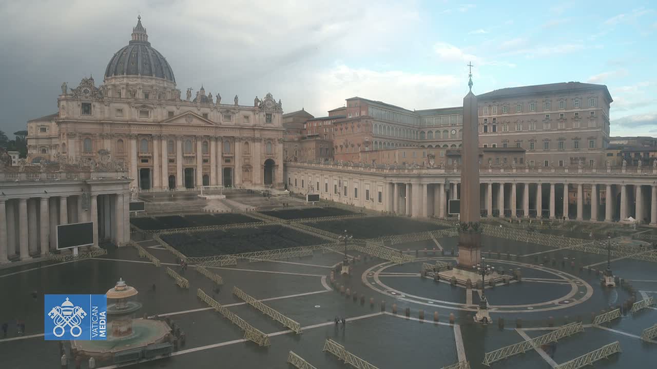 St. Peter's Basilica and St. Peter's Square are shown on an overcast day, with temporary fencing sectioning off portions of the square.