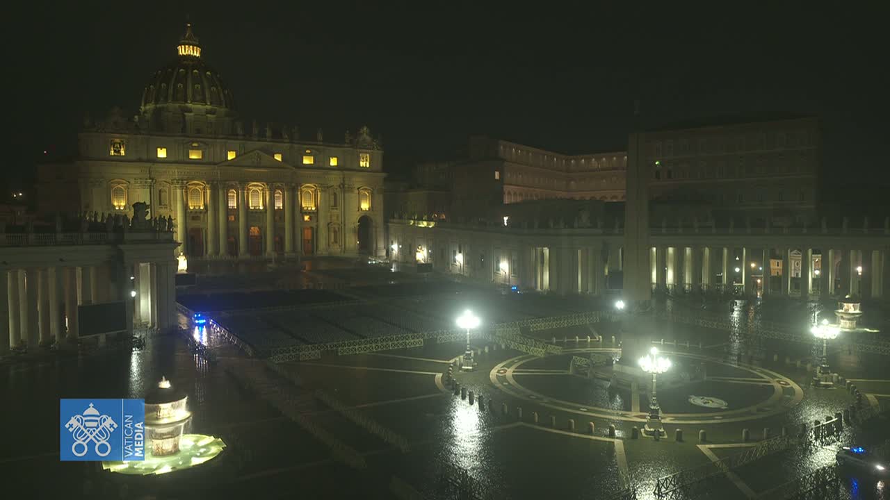 St. Peter's Basilica and Square at night in the rain, illuminated with lights.