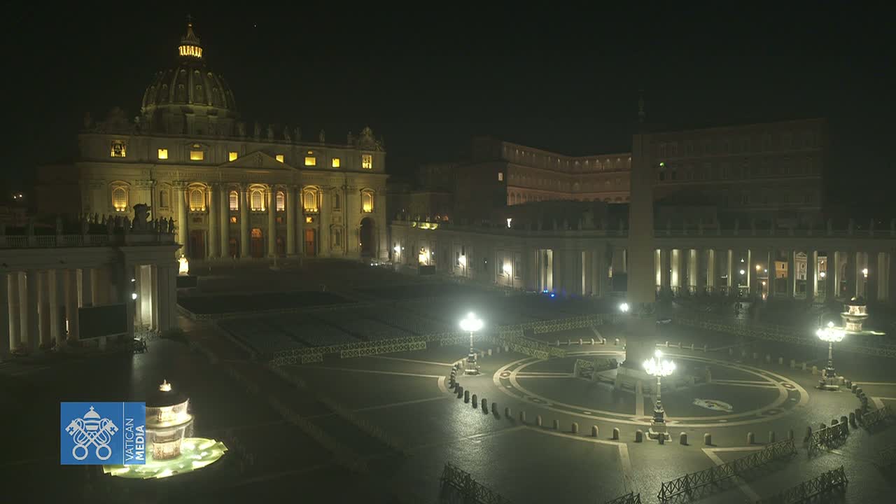 St. Peter's Basilica and St. Peter's Square are illuminated at night, with a fountain in the foreground.