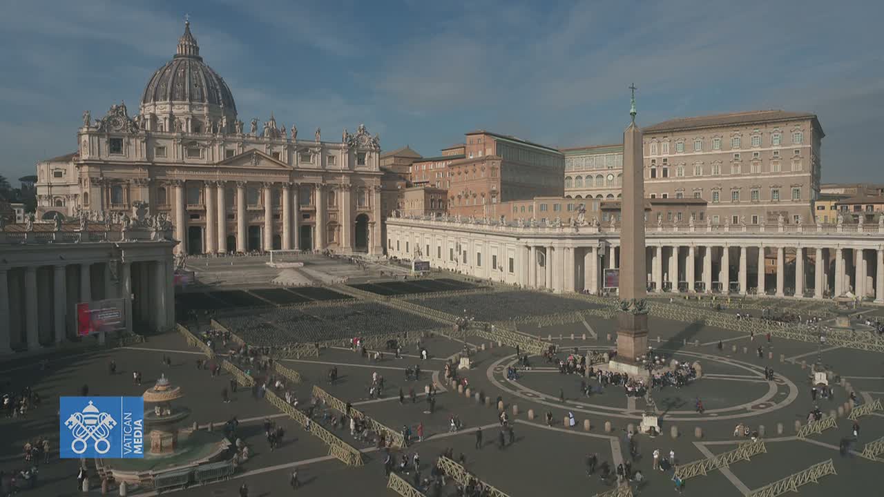 A large, mostly empty plaza in front of St. Peter's Basilica, under a mostly clear sky.