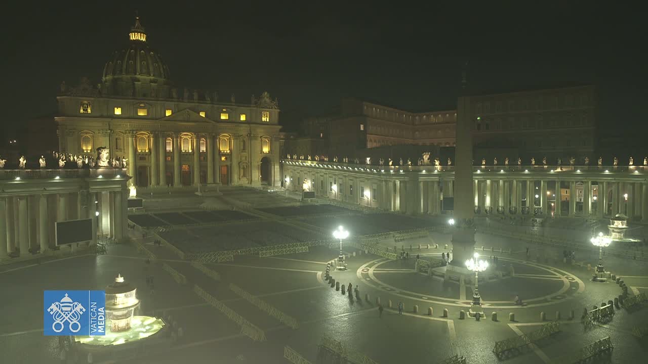 At night, St. Peter's Basilica and Square are illuminated, with a mostly empty square and a few people visible.