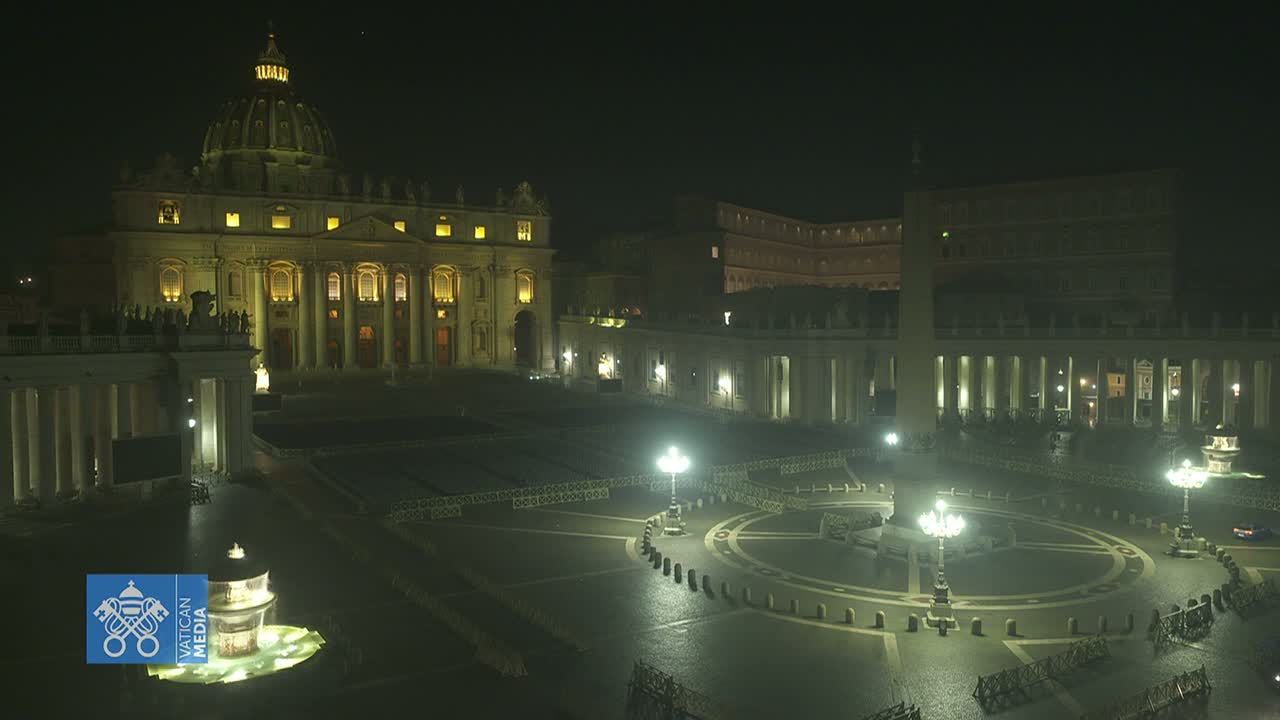 St. Peter's Basilica and St. Peter's Square are illuminated at night, appearing mostly empty under dark, clear skies.