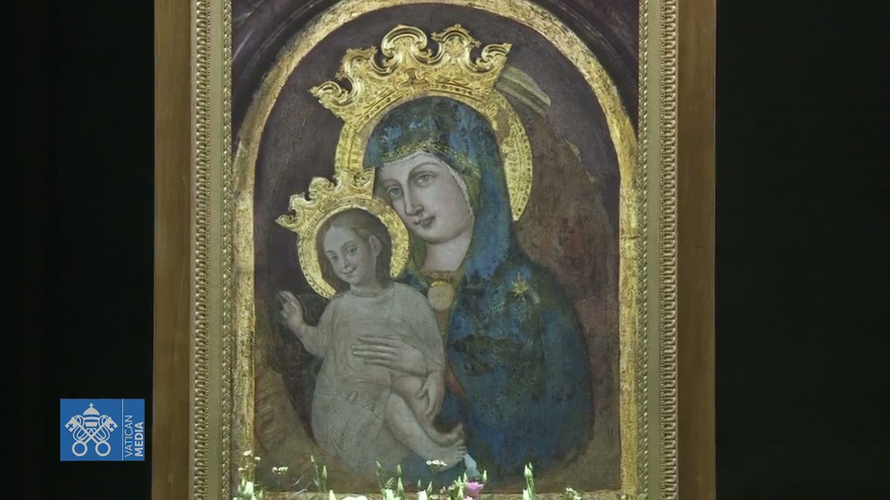 A painting of the Virgin Mary holding the baby Jesus is displayed in a gilded frame.