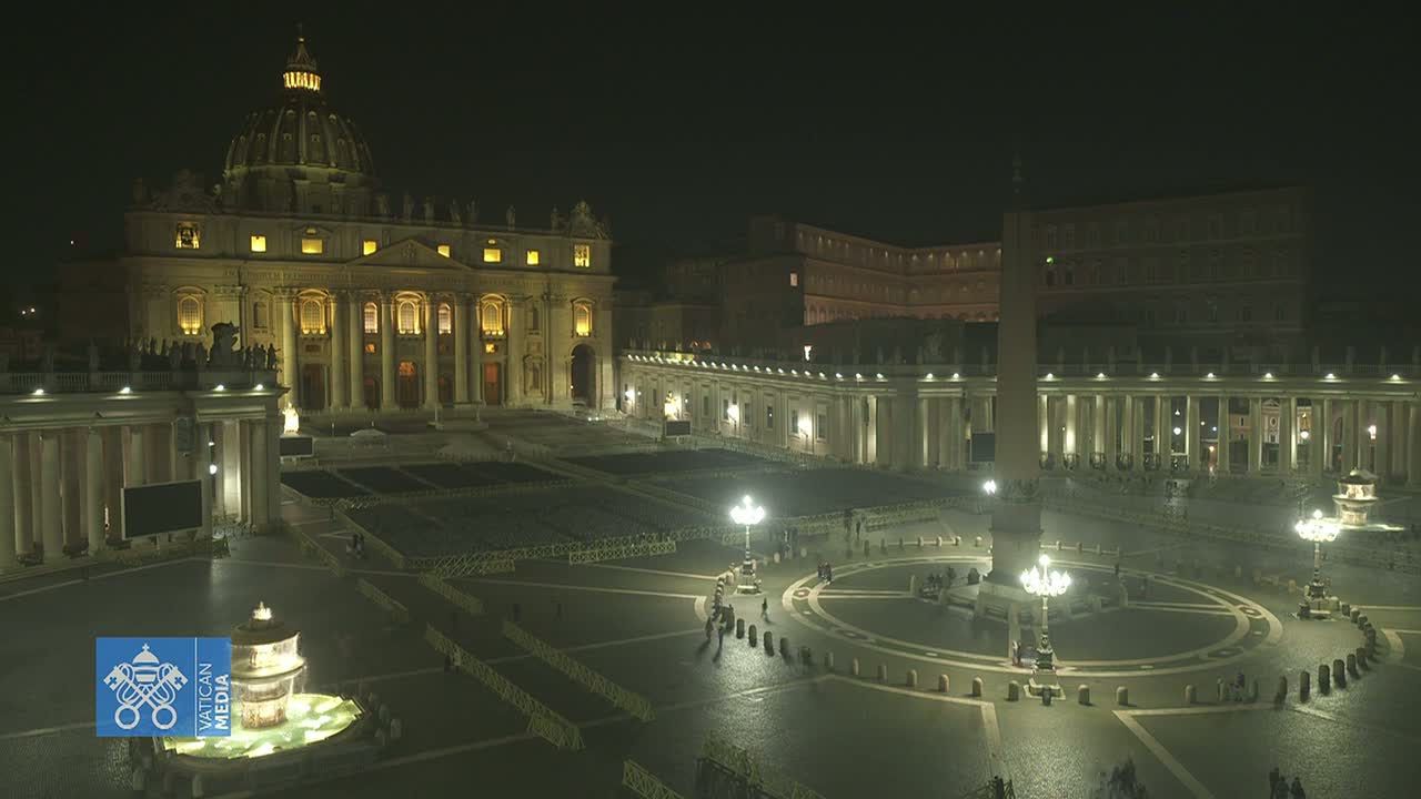 A brightly lit St. Peter's Square at night, featuring St. Peter's Basilica and the Vatican Obelisk.