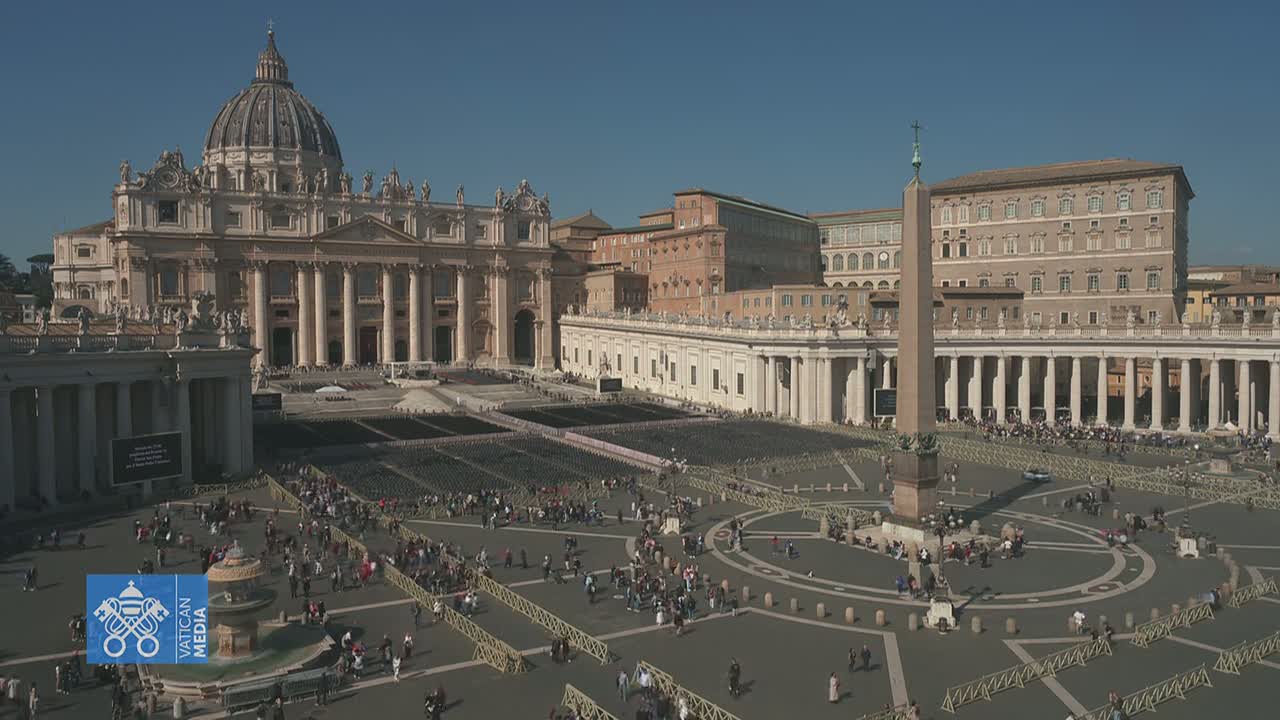 A large, mostly empty plaza with St. Peter's Basilica in the background under a clear, sunny sky.