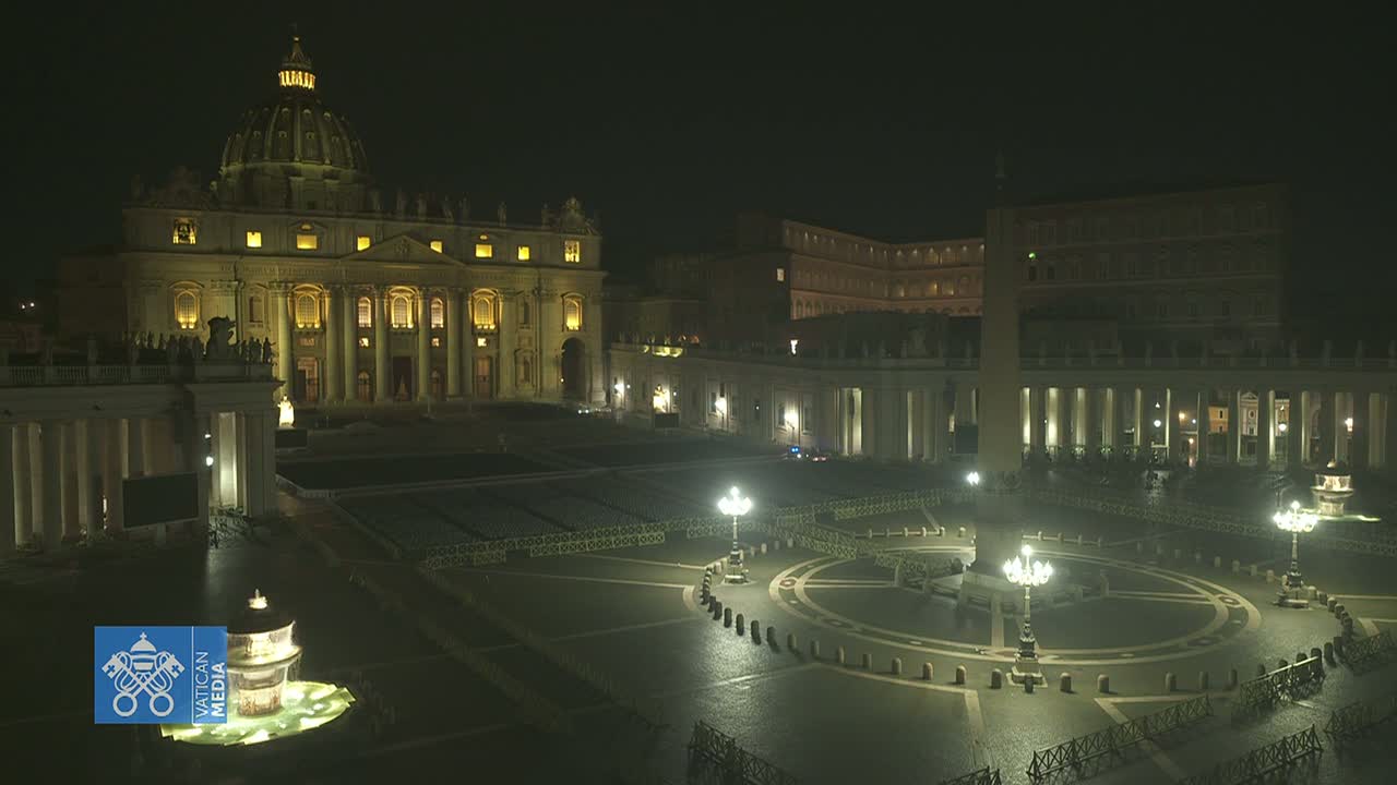 St. Peter's Basilica and its square are illuminated at night, appearing mostly empty under a dark sky.