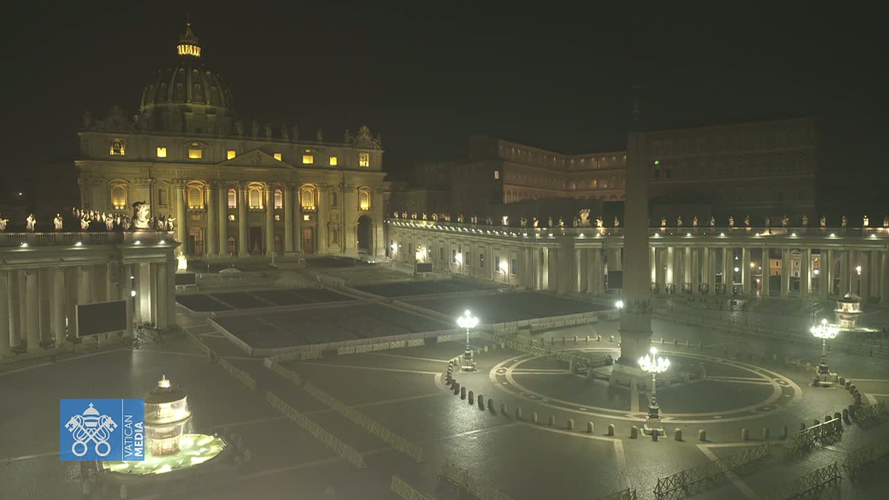 St. Peter's Basilica and Square are illuminated at night, appearing empty under a dark sky.