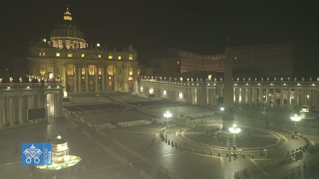 At night, St. Peter's Basilica and Square are illuminated, showing a mostly empty plaza with a few people sparsely scattered throughout.