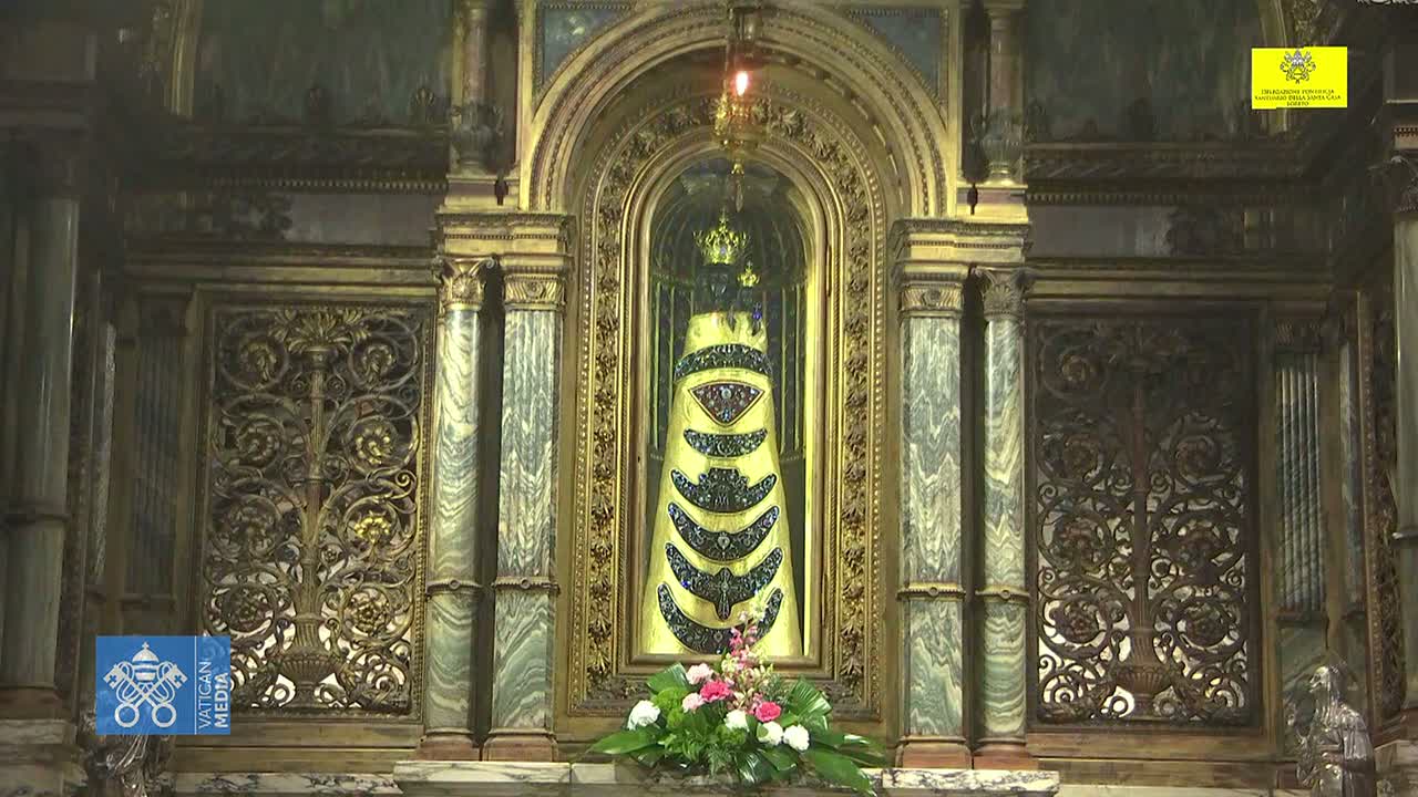 An ornate, gold-and-marble altar displays a jeweled, conical reliquary, adorned with flowers at its base.