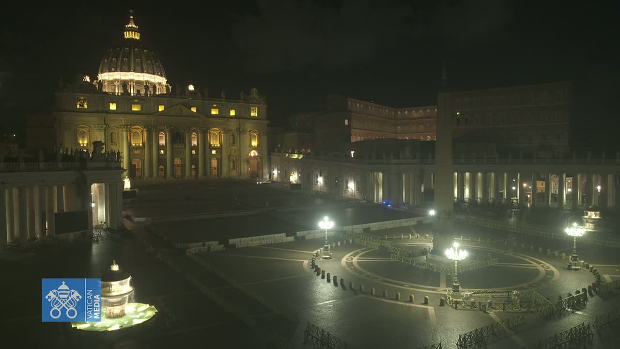 St. Peter's Basilica and St. Peter's Square are illuminated at night, appearing mostly empty under dark, possibly overcast, conditions.