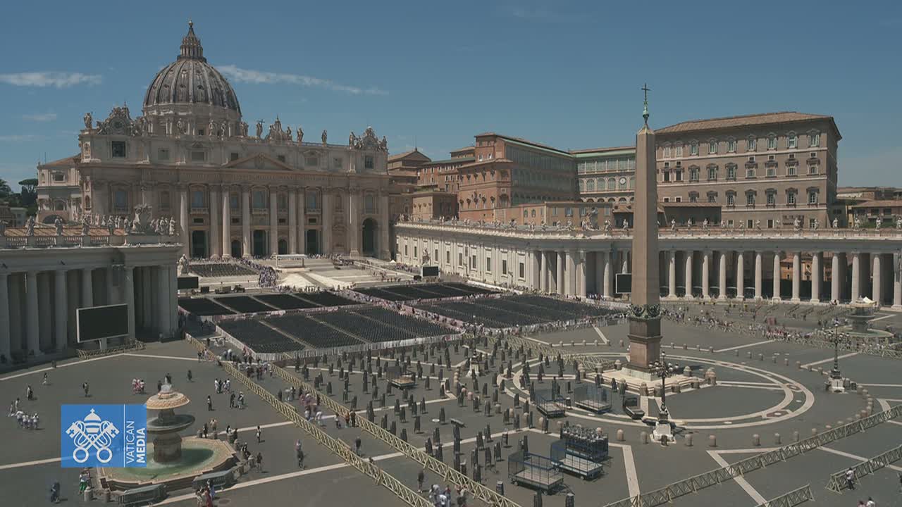 St. Peter's Basilica and St. Peter's Square in Vatican City are shown on a sunny day, with many chairs set up in the square and a few people walking around.