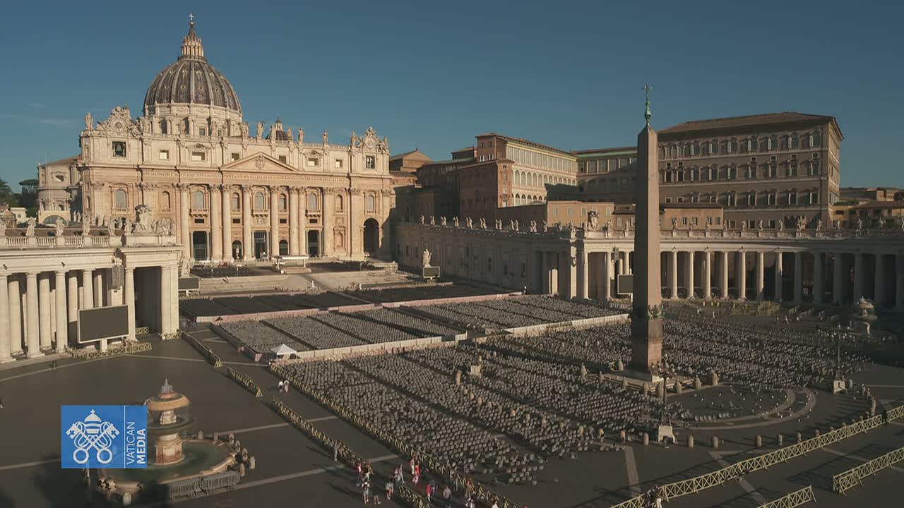 St. Peter's Basilica and Square are shown on a sunny day, with numerous chairs set up in the square.