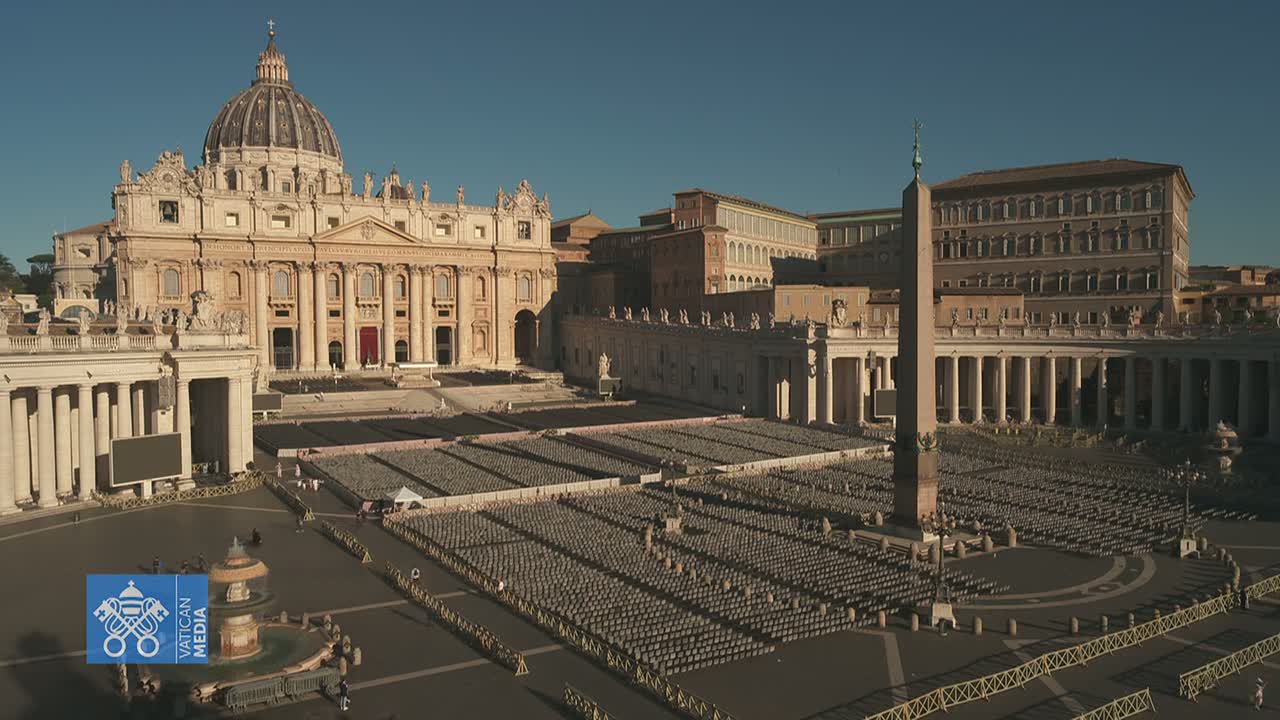 St. Peter's Basilica and Square, under a clear sky, are shown with many empty chairs set up in the square.