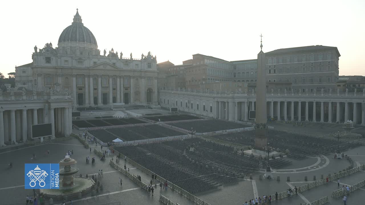 St. Peter's Square in Vatican City is filled with rows of empty chairs under a hazy, bright sky.