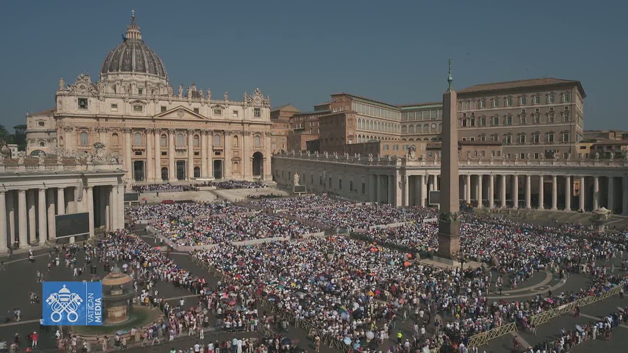 A large crowd gathers in St. Peter's Square in front of St. Peter's Basilica on a clear, sunny day.