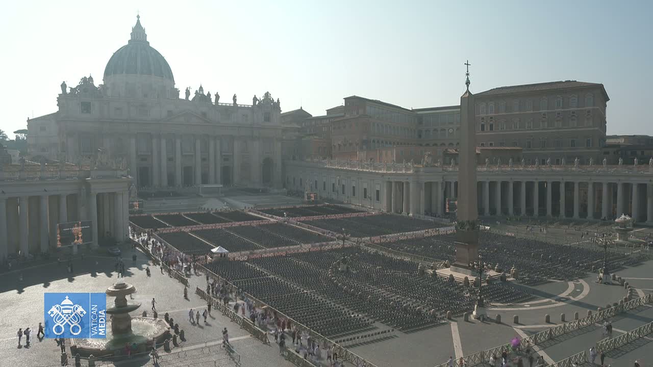 St. Peter's Basilica and Square in Vatican City are filled with many empty chairs, under a hazy, sunny sky.