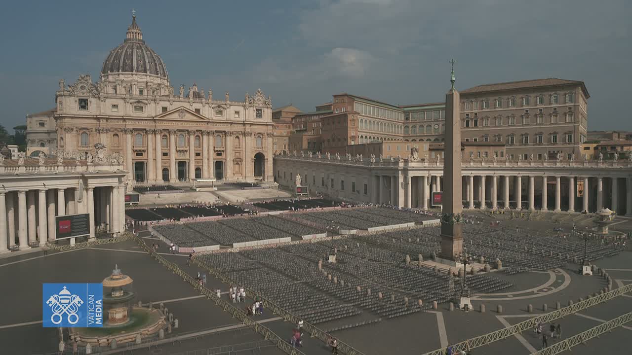St. Peter's Basilica and Square are shown on a sunny day, with numerous chairs set up in the square.