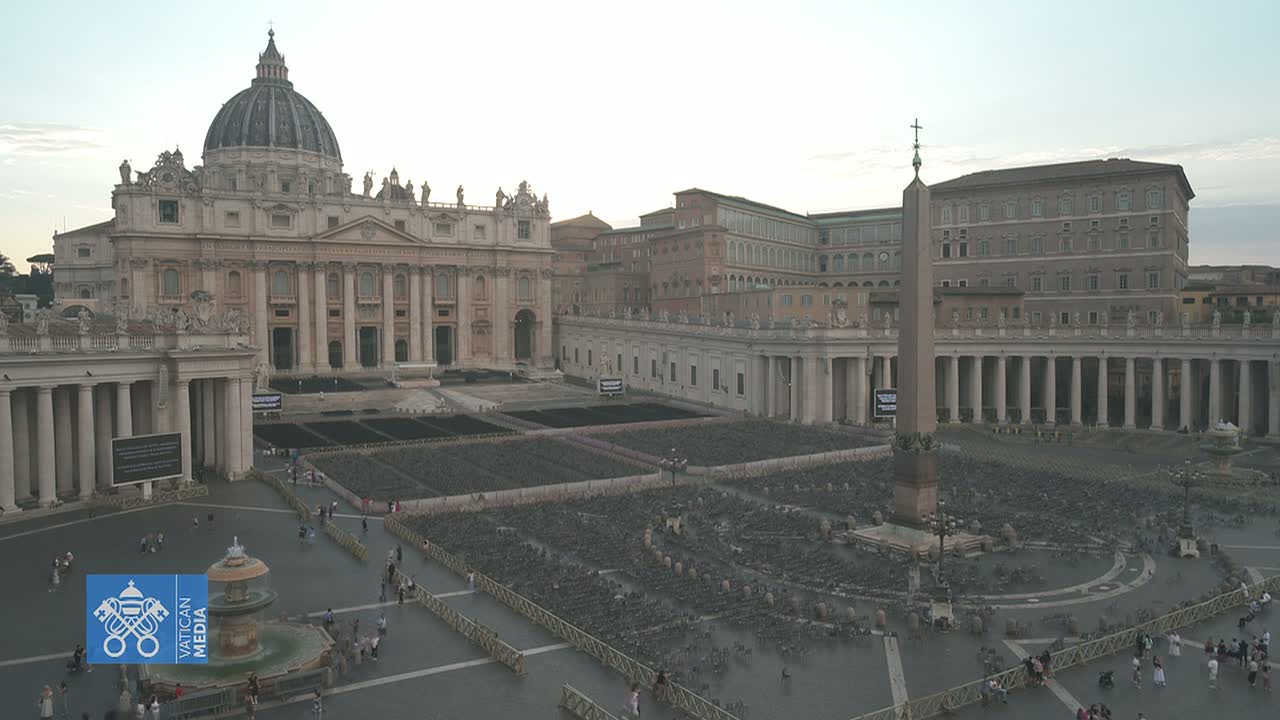 St. Peter's Basilica and Square in Vatican City are shown on a partly cloudy day, with numerous chairs set up in the square.