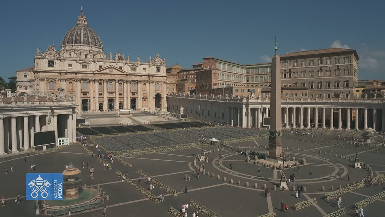 A large, sunlit plaza with St. Peter's Basilica and an obelisk, surrounded by colonnades and sparsely populated with people.