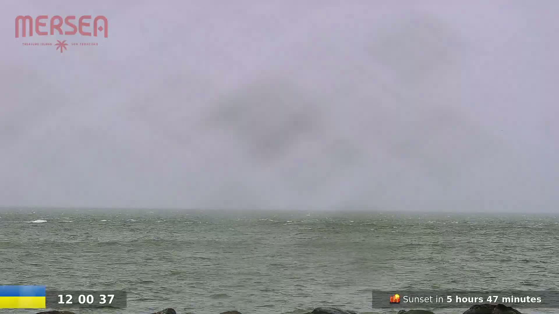 A foggy, gray day at sea with a slightly choppy ocean.