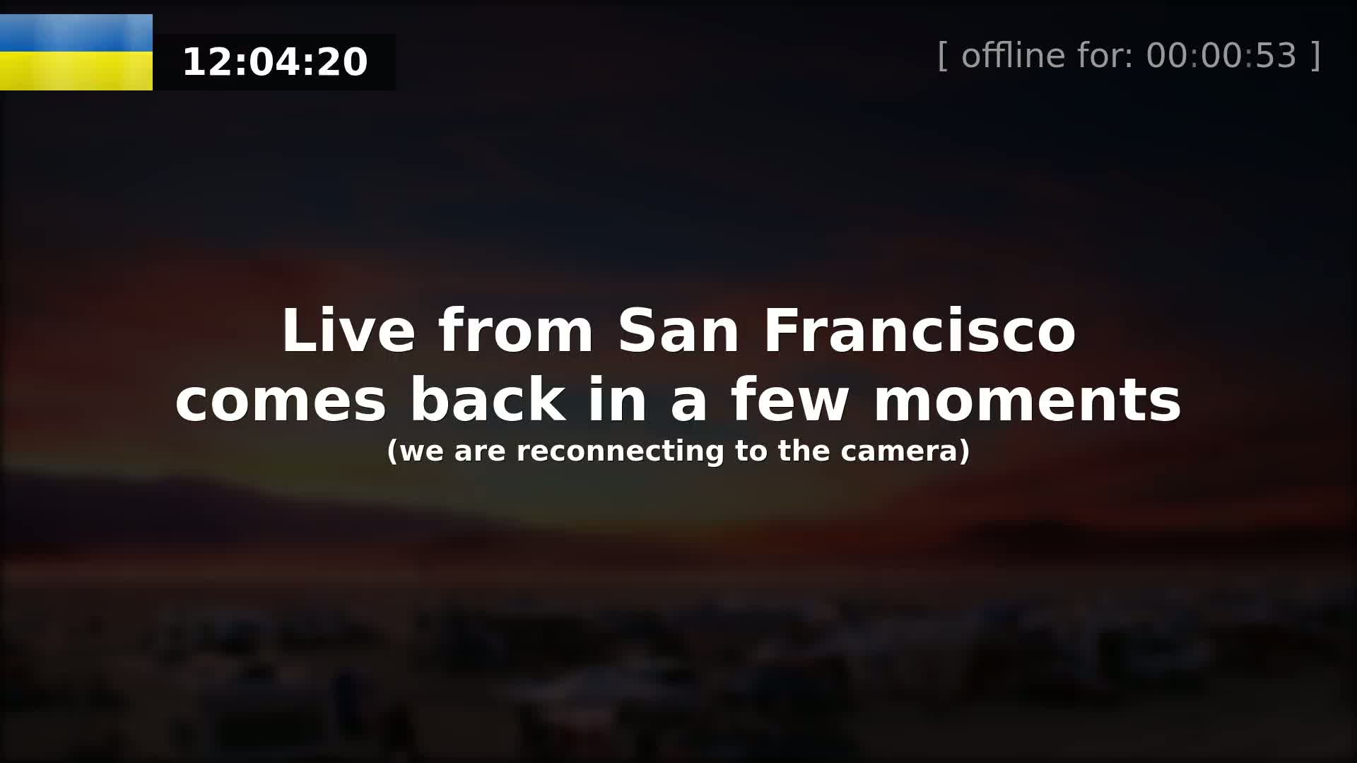 A blurry, dark outdoor image of a landscape at sunset or sunrise shows a scene possibly from San Francisco.