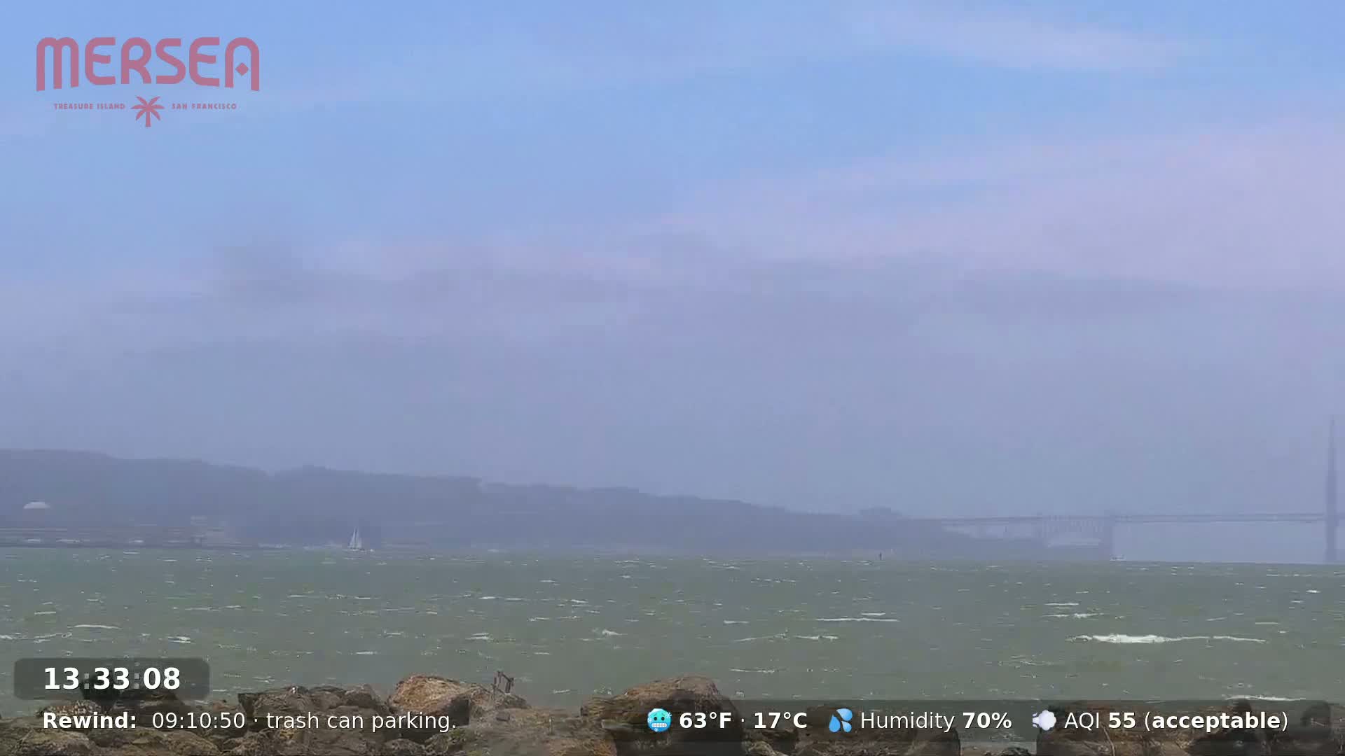 A hazy, foggy view shows Alcatraz Island across a body of water.
