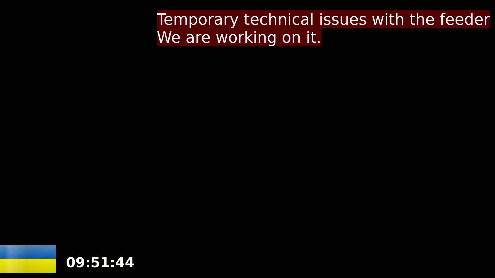 The image is a completely black screen with a small Ukrainian flag and a time stamp in the bottom left corner.