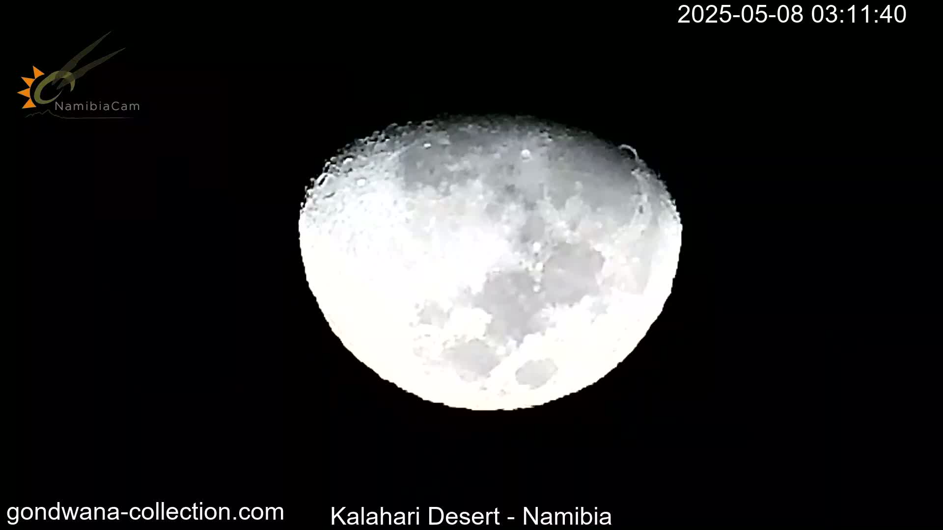 A brightly lit, partially visible moon is seen in a dark night sky.