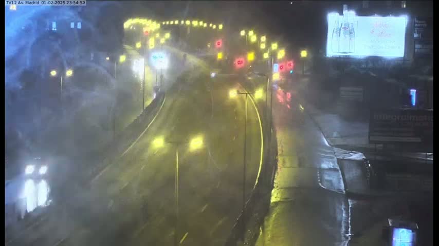 A rain-soaked highway interchange at night is visible, with cars driving through heavy rain under illuminated streetlights.