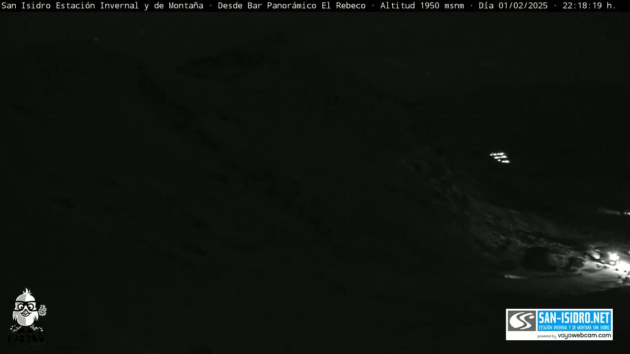 A nighttime, low-light view of a snow-covered mountain slope.