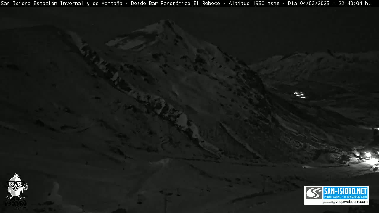 A nighttime, low-light view of a snow-covered mountain slope.