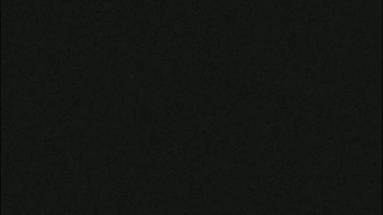 The image shows a dark gray or black textured surface.
