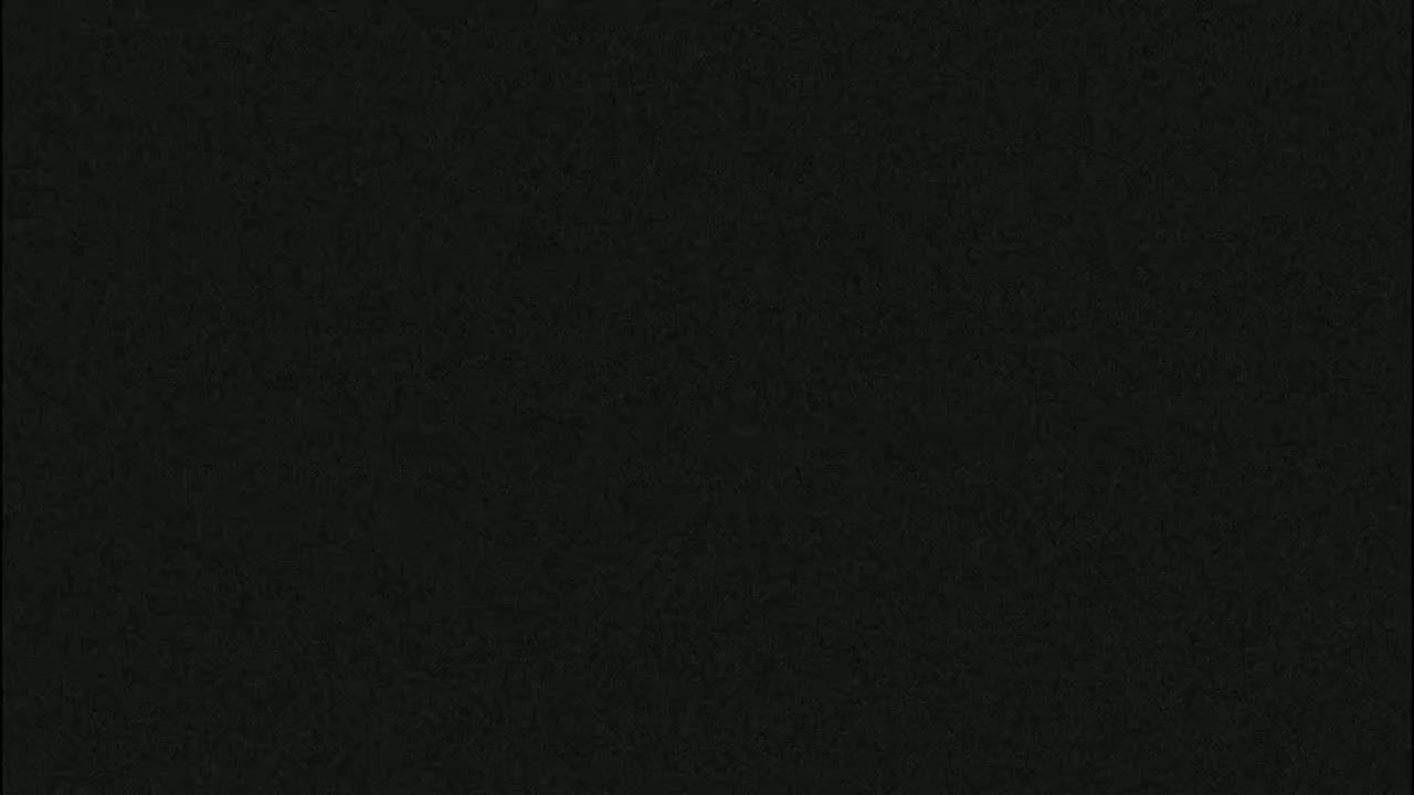 The image shows a dark gray or black textured surface.